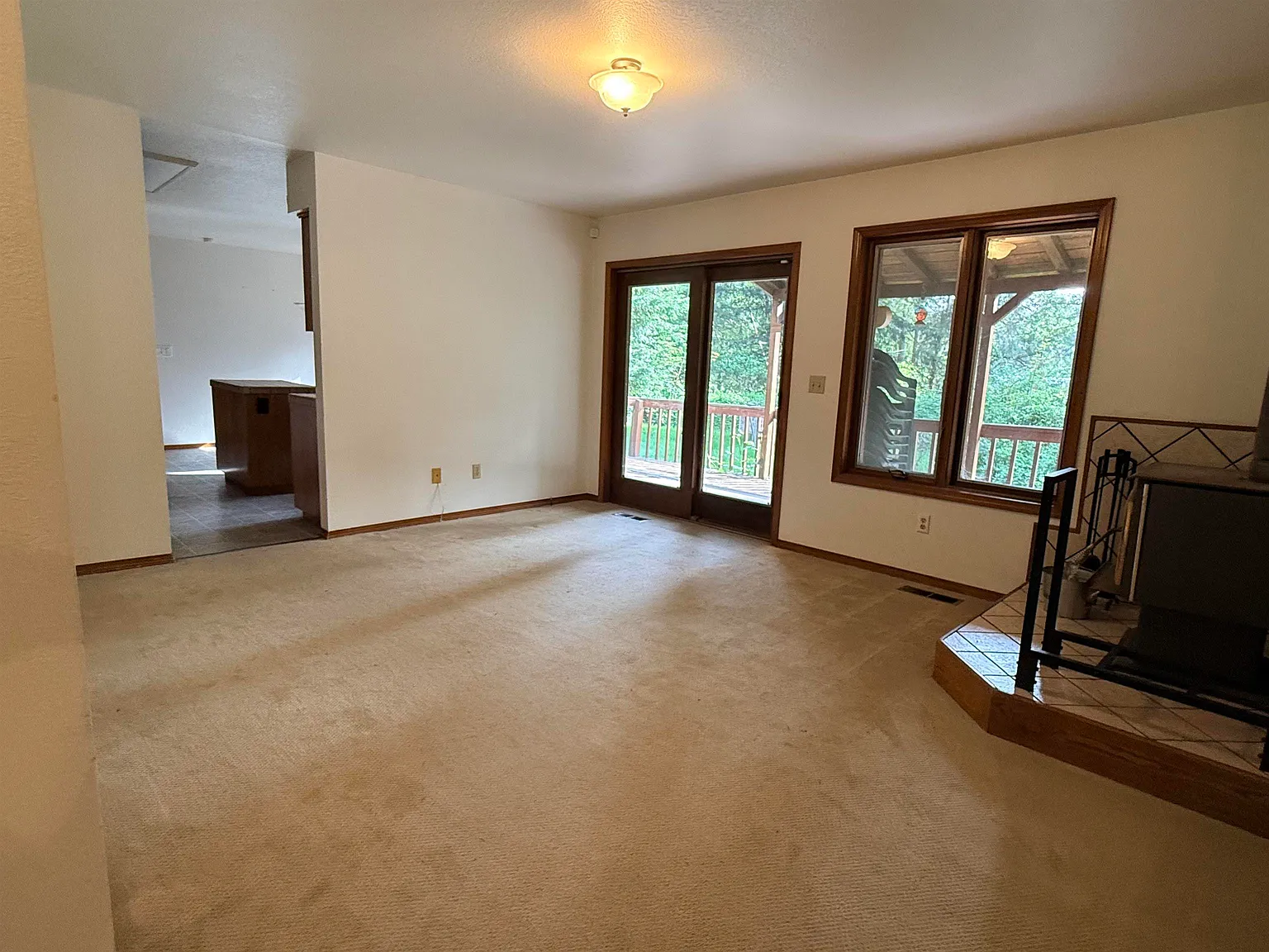 Living room with French doors opening onto the back deck.